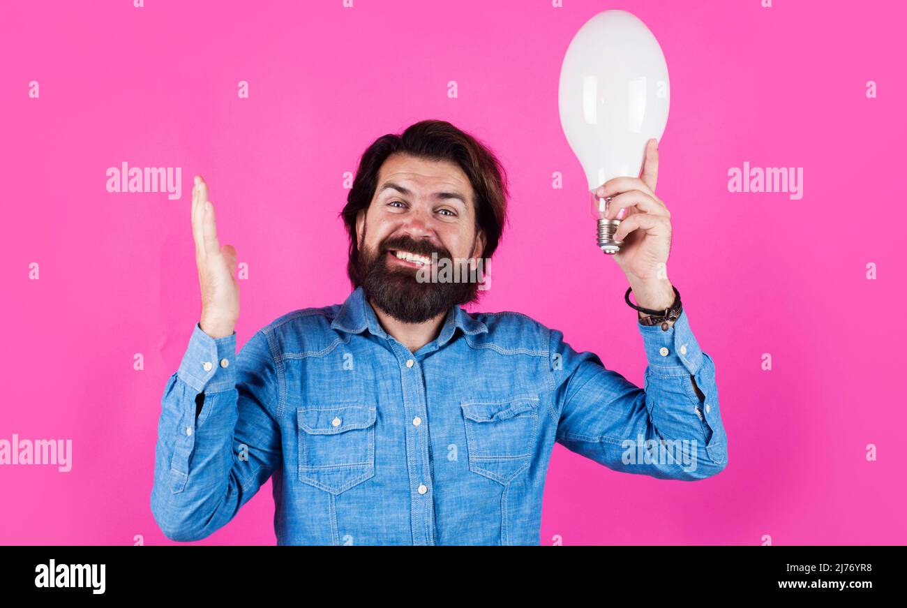 Happy bearded man with light bulb. I have idea. Birth of ideas. Male with lamp. Stock Photo