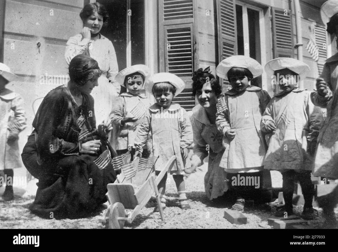 Genoa. Children of refugees and poor soldiers families at the creche, or kindergarten recently opened for them in Genoa. The children are fressed in the aprons and caps furnished them at this ARC nursery, June 1918 Stock Photo