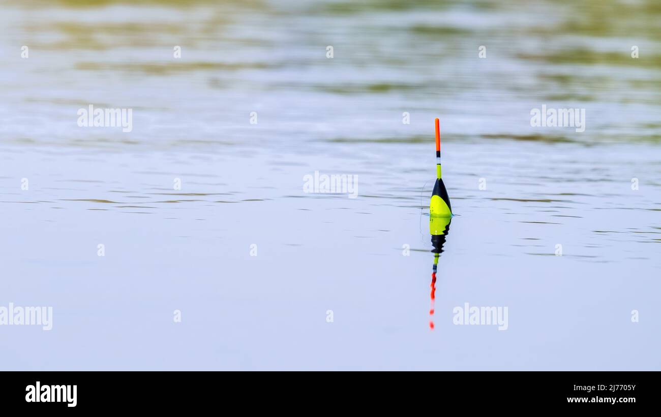 Orange bobber on the water surface Stock Photo