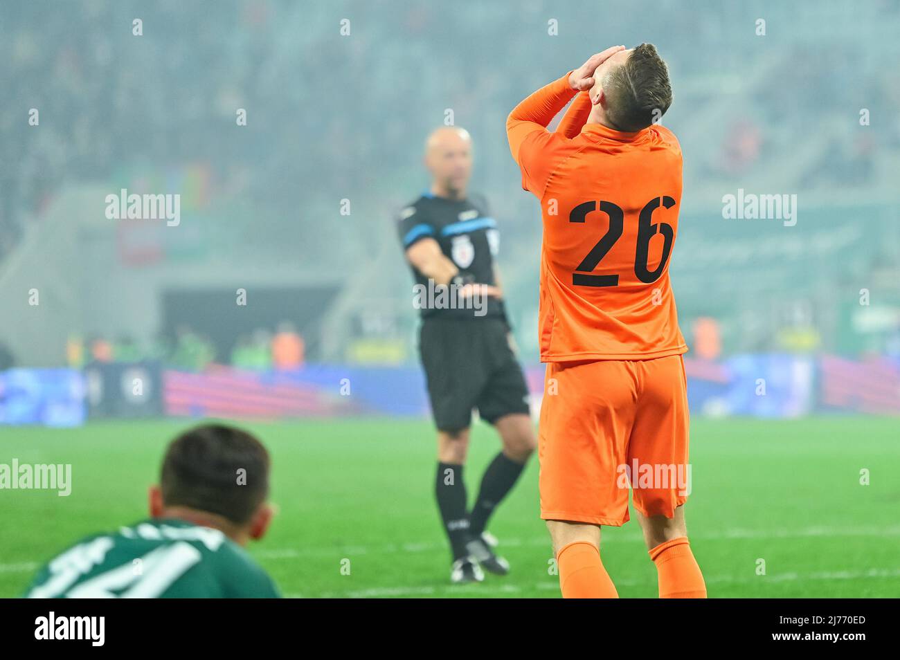 The gesture of a footballer after he missed during football match in the stadium Stock Photo
