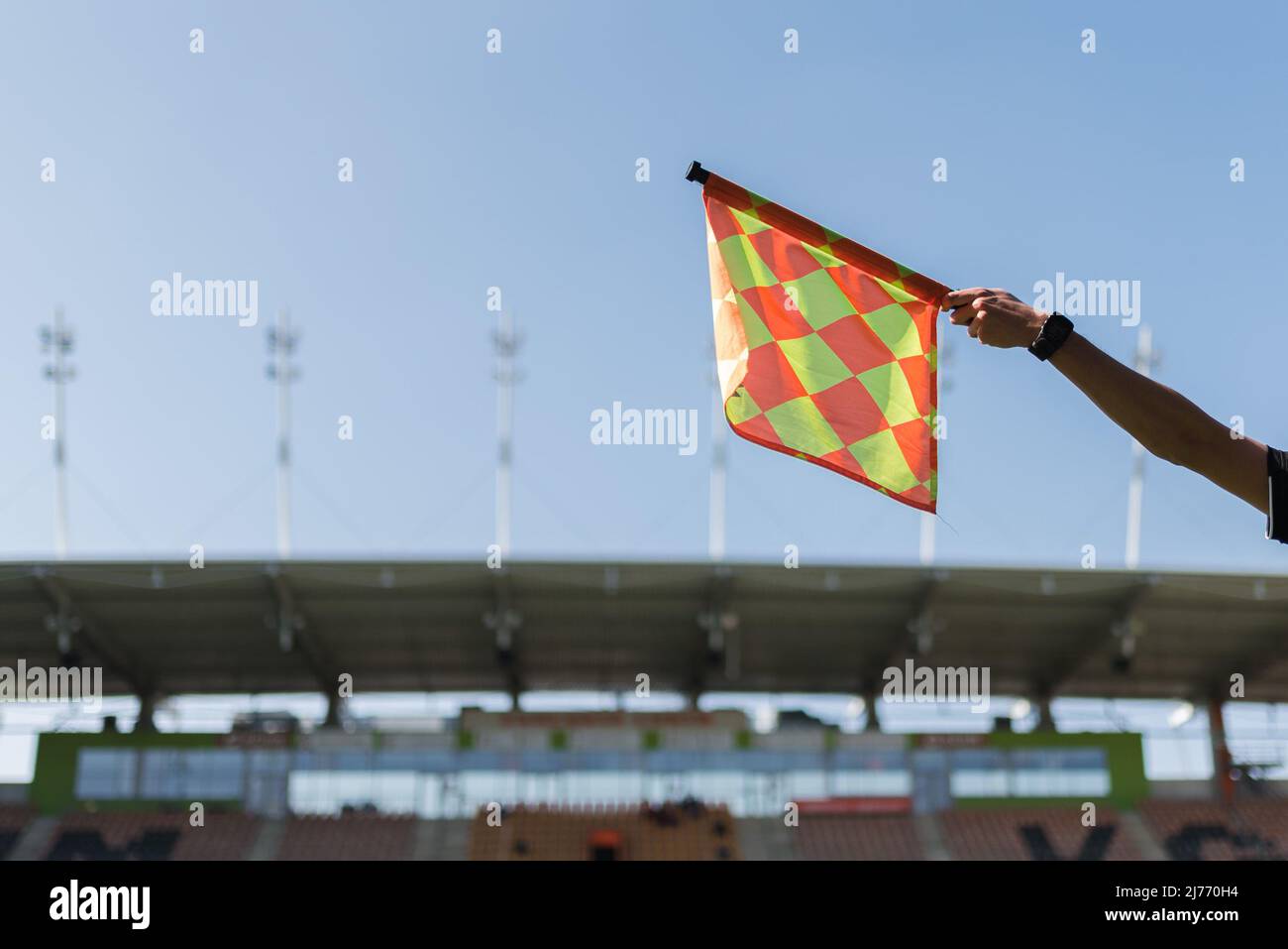 reise soccer referee flag with stadium roof in the background Stock Photo