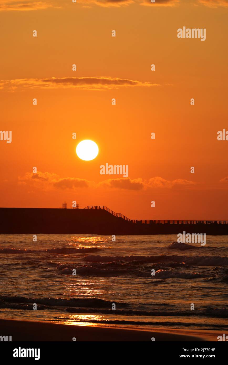 Sunset over the sea seen from the Uchinada coast in Ishikawa prefecture, Japan Stock Photo