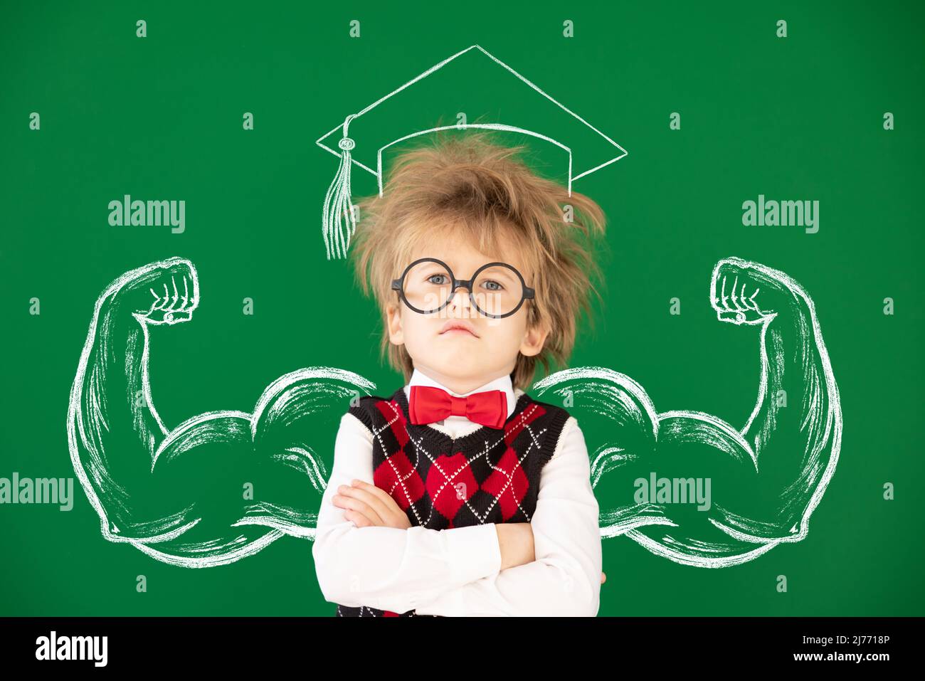 Funny child student in class. Happy kid against green chalkboard. Education concept. Back to school Stock Photo