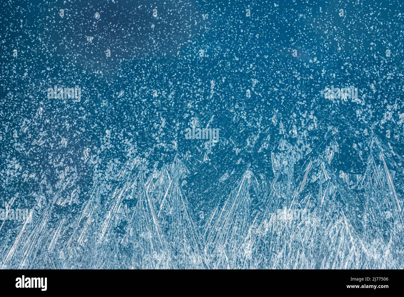 Frost patterns on frozen winter window as a symbol of Christmas wonder ...