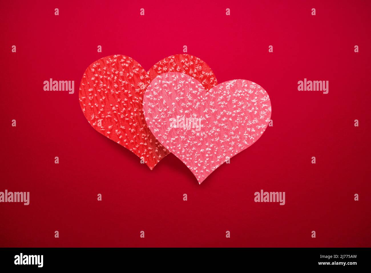 Red background with double hearts (red and pink), romantic background for Valentine's Day or wedding. Stock Photo