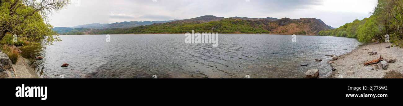 Stunning panoramic of Llyn Gwynant on a beautiful cloudy day, isolated and still, nr Beddgelert, Gwynned, North Wales Stock Photo