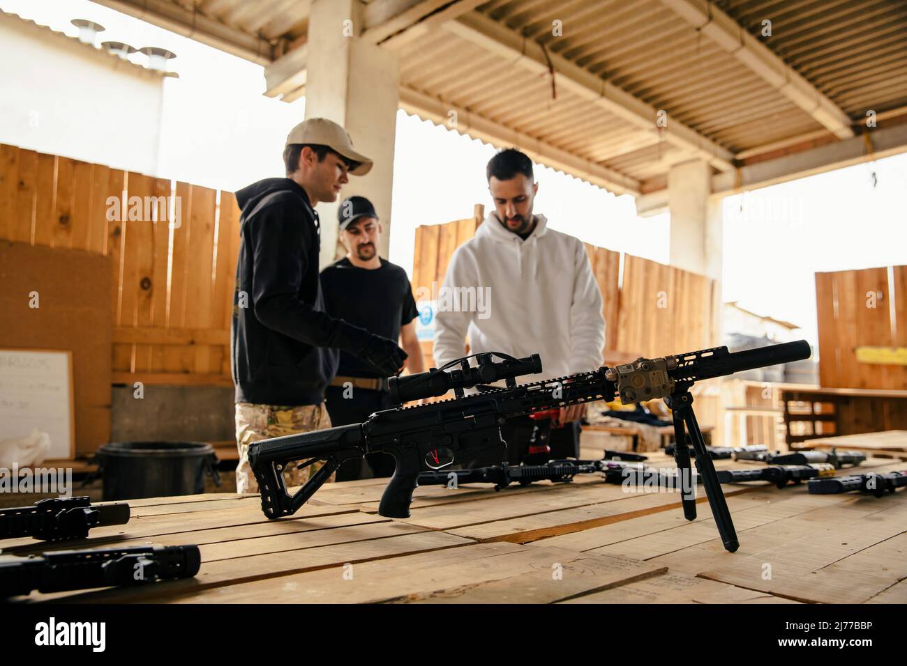 Airsoft soldiers preparing for battle at training ground Stock Photo