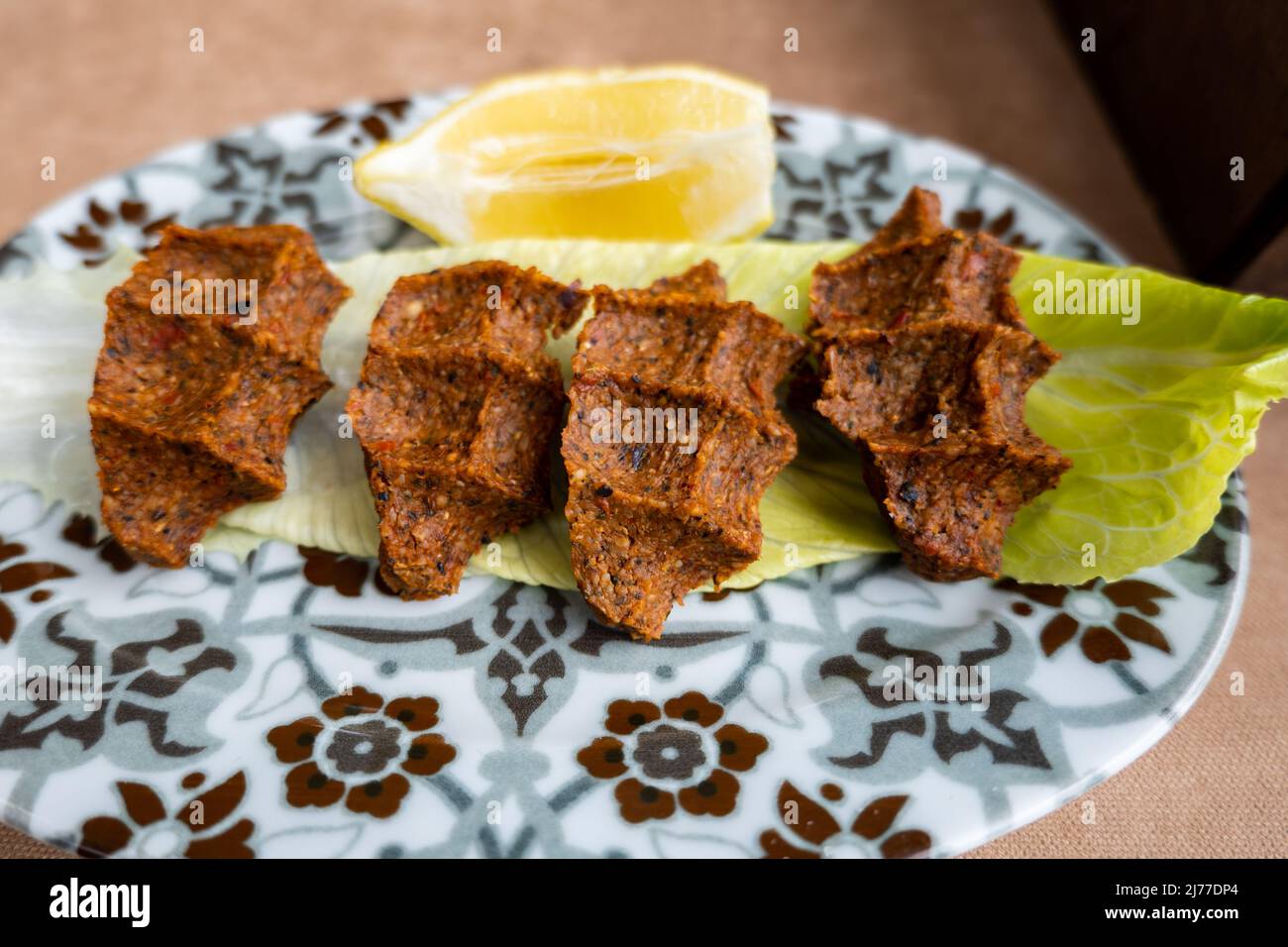 Cig Kofte (raw meatball in Turkish) with lettuce, traditional Turkish cuisine popular in Turkey Stock Photo