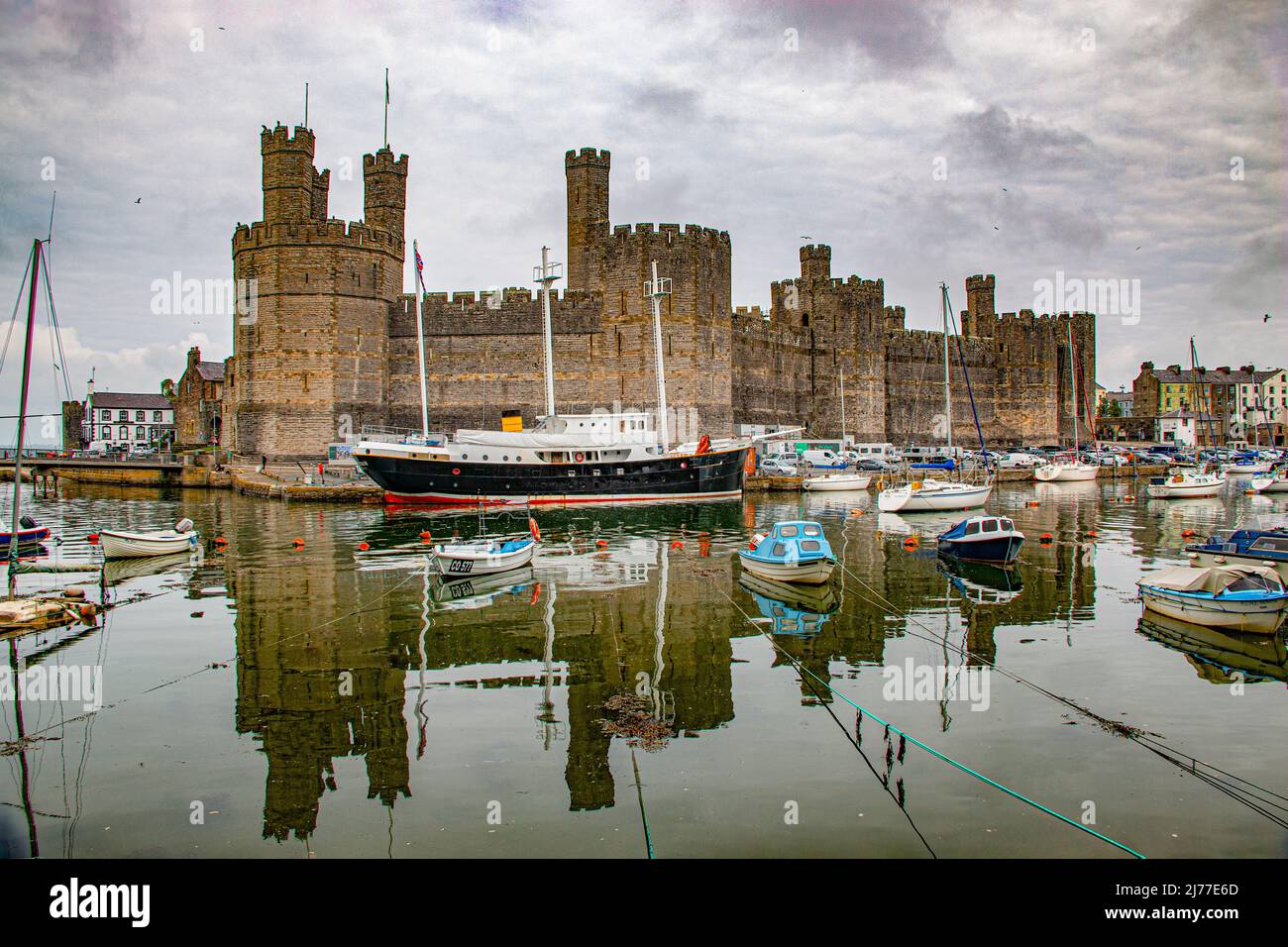 Perfect reflection of Caernarfon Castle in the Menai Strait at low tide