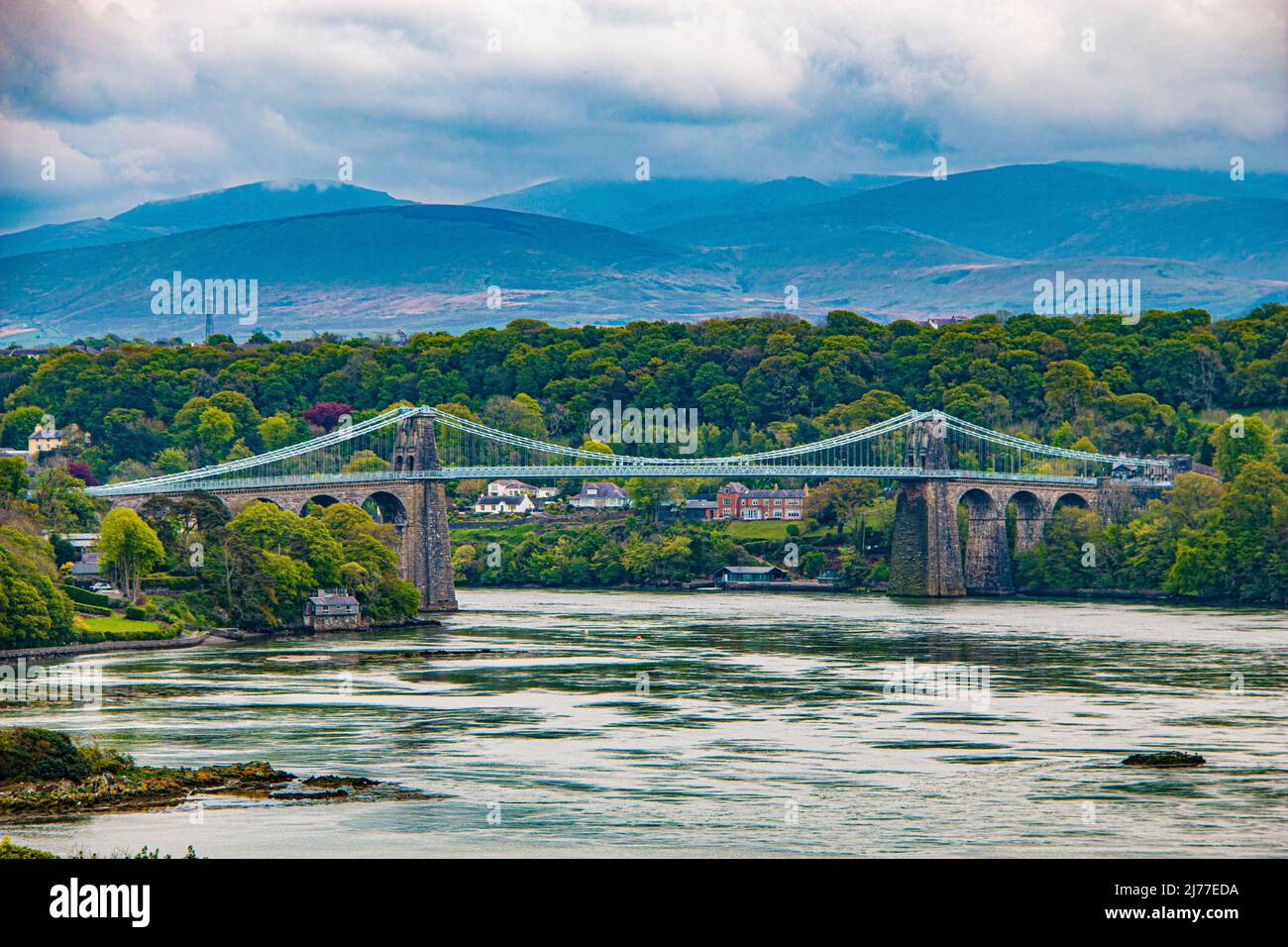 The Menai suspension bridge, over the Menai,designed by Thomas Telford to connect the mainland with the island of Anglesey, North Wales Stock Photo