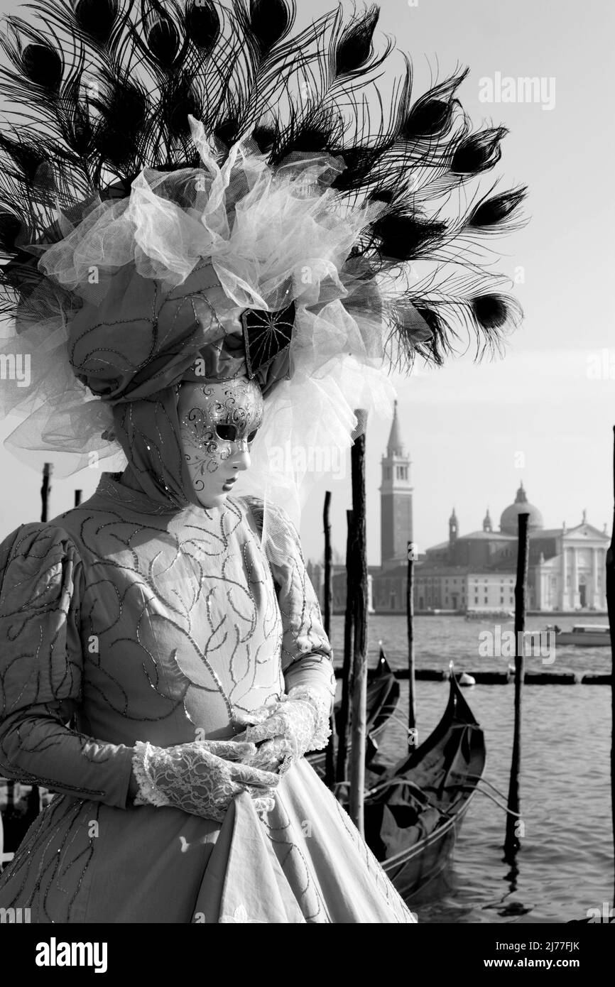 VENICE, ITALY - FEBRUARY 26, 2011: The blue mask from carnival and church San Giorgio Maggiore in the background. Stock Photo