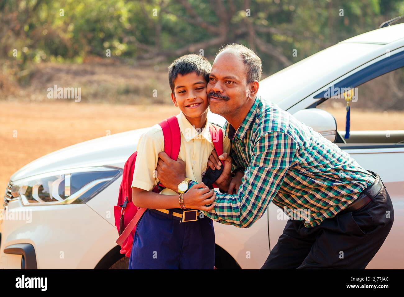 indian family driving boys to school In front of house gates Stock Photo Alamy