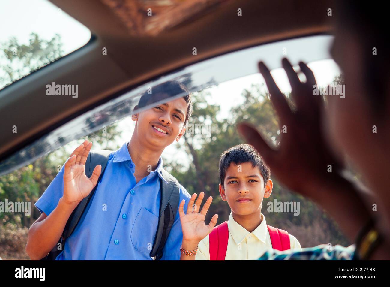 indian family driving boys to school In front of house gates Stock Photo Alamy