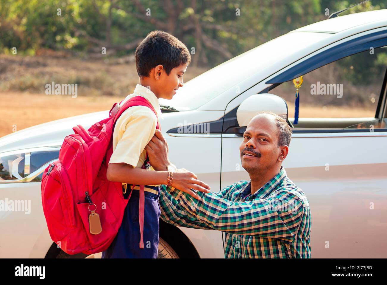 indian family driving boys to school In front of house gates Stock Photo Alamy