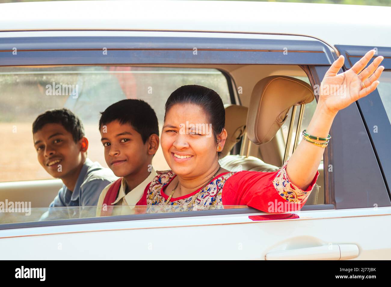 indian family driving boys to school In front of house gates Stock Photo Alamy