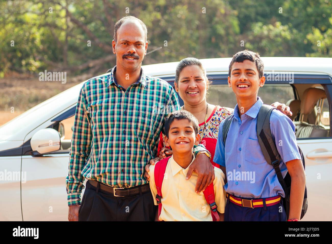 indian family driving boys to school In front of house gates Stock Photo Alamy