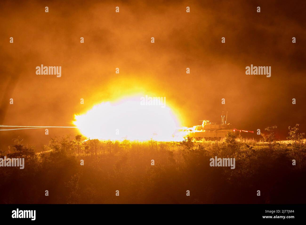 An M1A2 SEPv2 Abrams tank fires down range during the table VI night fire portion of Sullivan Cup at Fort Benning, Georgia, May 4, 2022. The Sullivan Cup highlights and validates training and education required to employ the latest advancements of Armor modernization in support of Armored Brigade Combat Teams and Cavalry formations. (U.S. Army photo by Sgt. William Griffen, 50th Public Affairs Detachment) Stock Photo