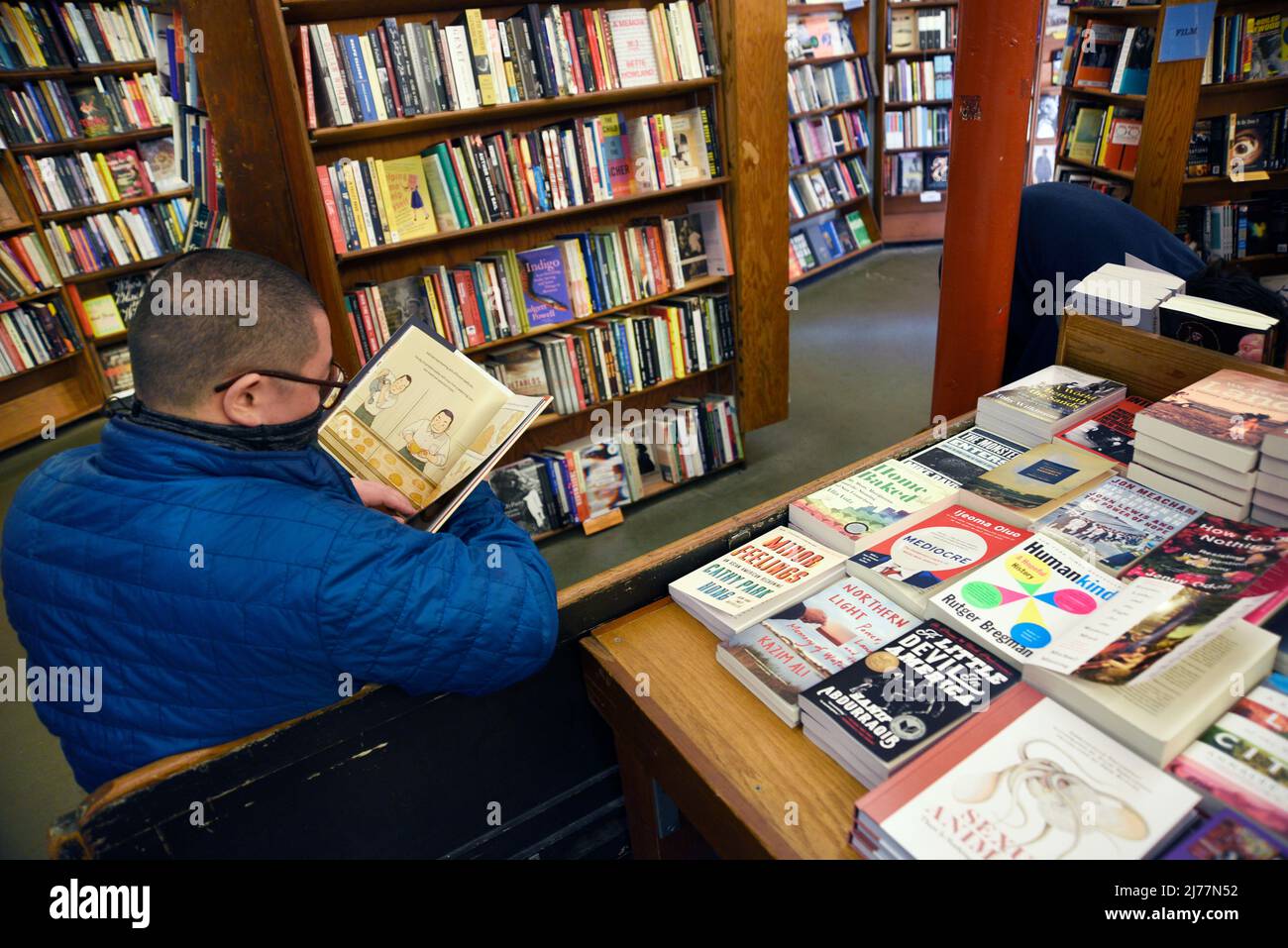 A customer peruses shelves of books for sale in the landmark City