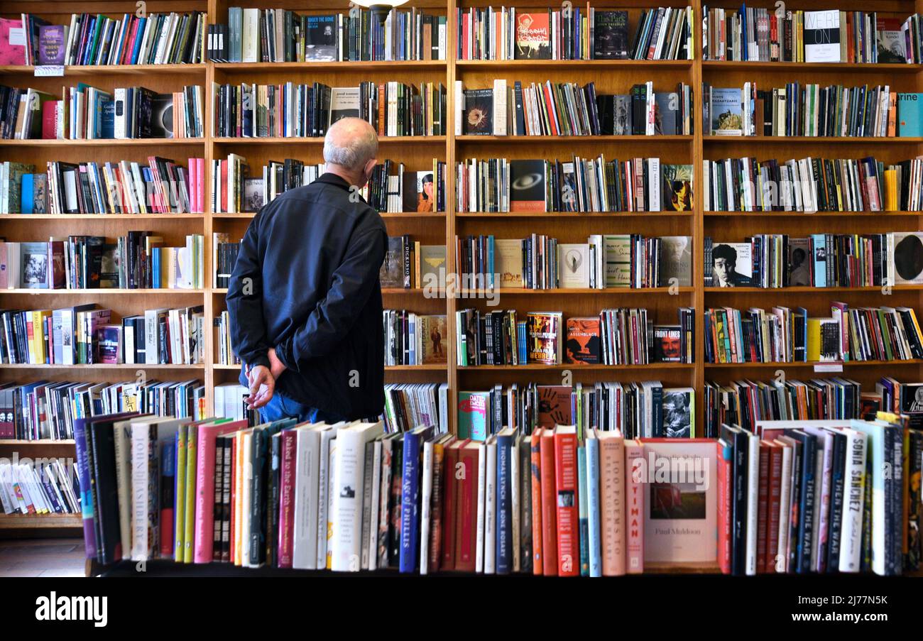 A customer peruses shelves of books for sale in the landmark City