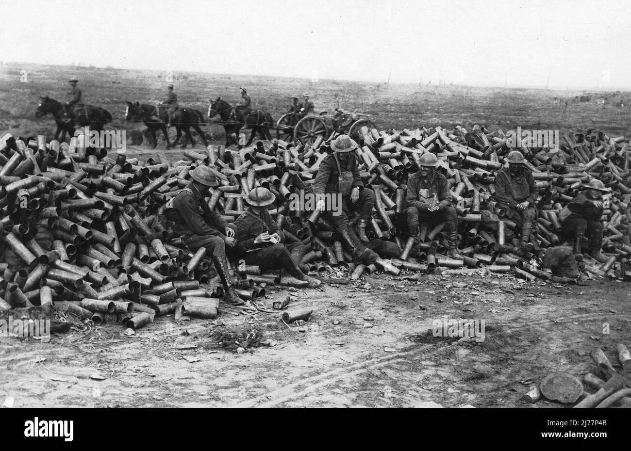 Soldiers resting on a huge pile of shell cases during the Battle of Menin Road at Ypres, 1917 Stock Photo