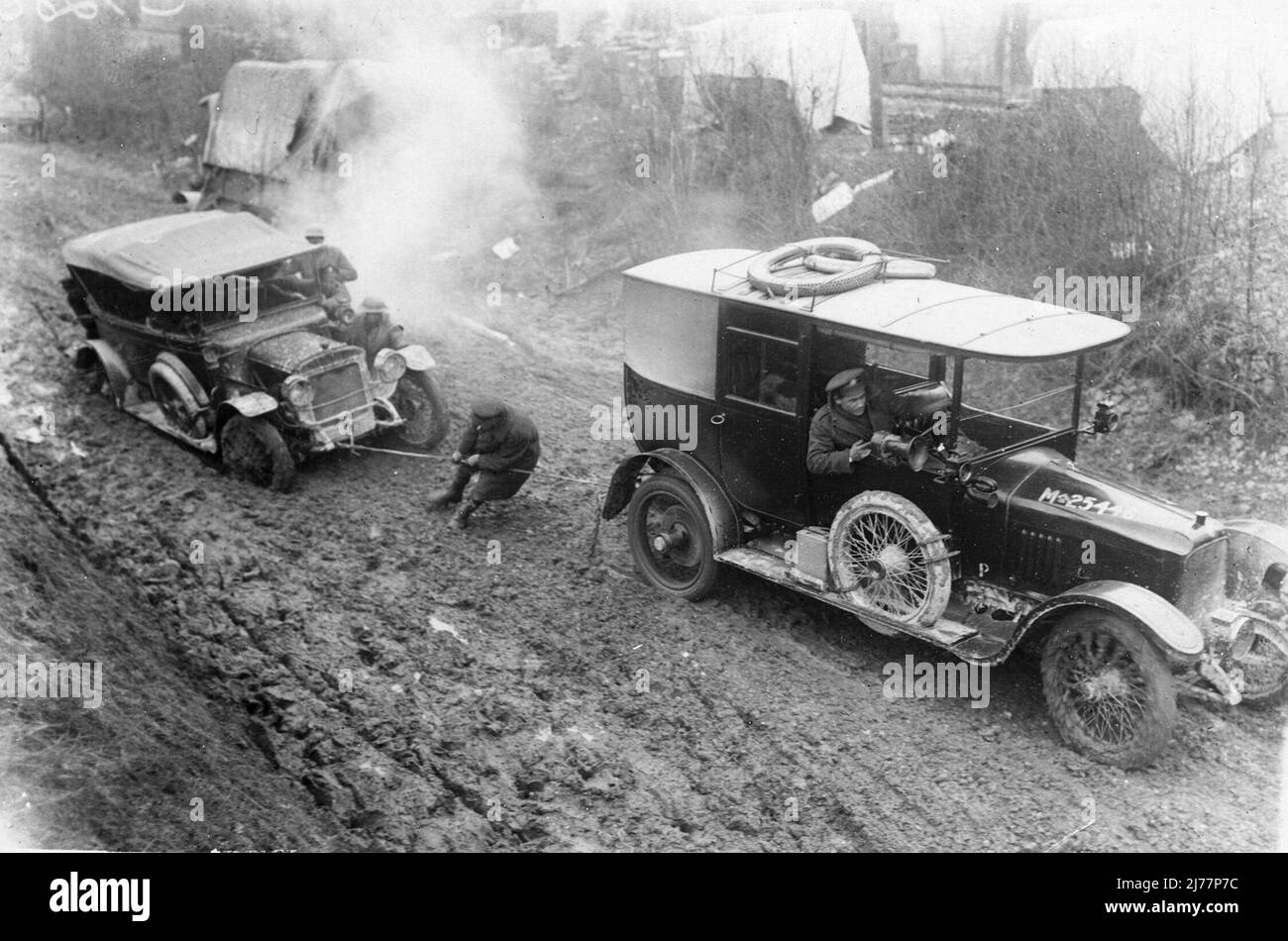 British Army motor car, M-25446, (Vauxhall 25 limousine) towing anpther (possible a Daimler Twenty) out of the mud at Hamel, January 1917. Stock Photo