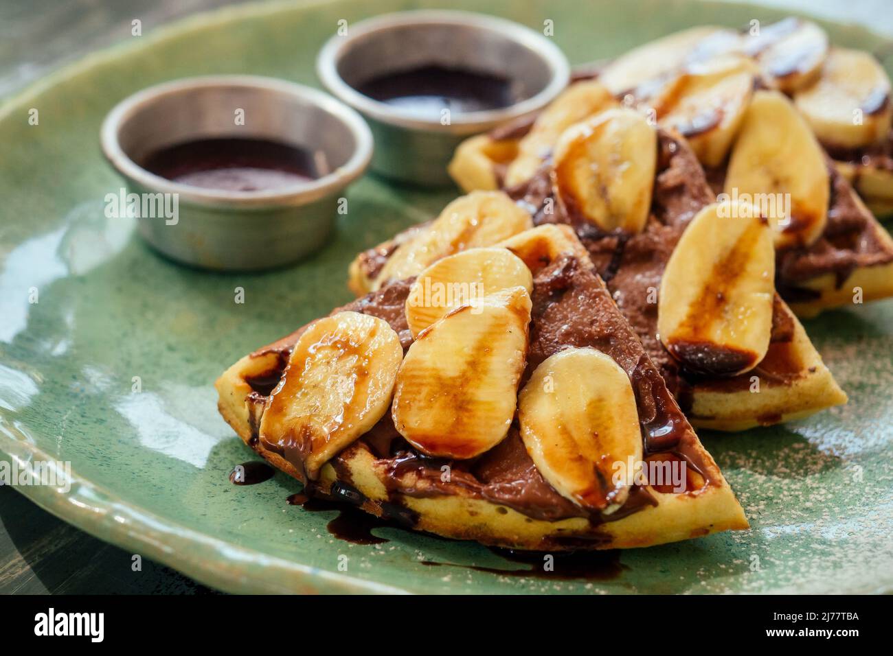 Belgian waffles with banana and chocolate topping Stock Photo - Alamy
