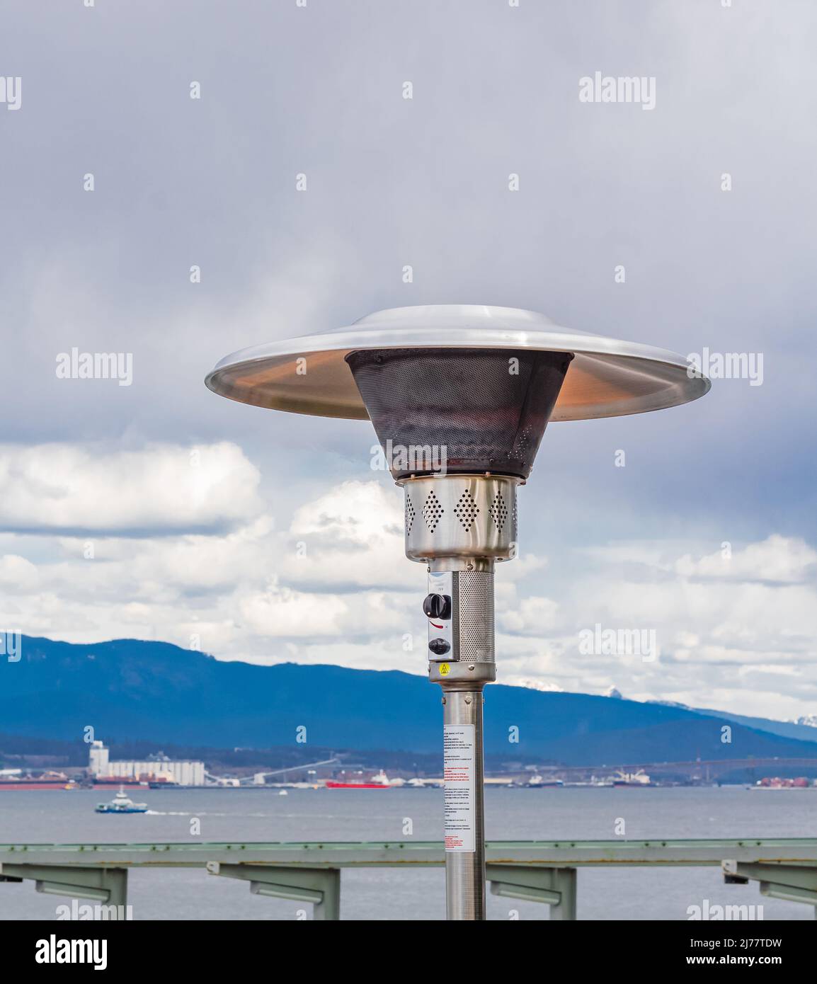 Round Mushroom Propane Patio Heater in outdoor restaurant patio. Gas heater for patio-Vancouver BC. Street photo, travel photo, selective focus, nobod Stock Photo
