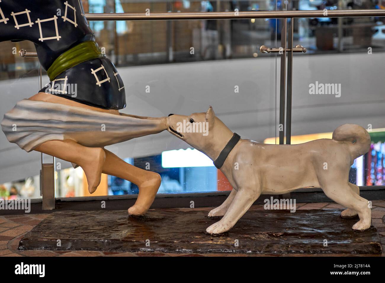 Funny statue of dog pulling down boys trousers Stock Photo