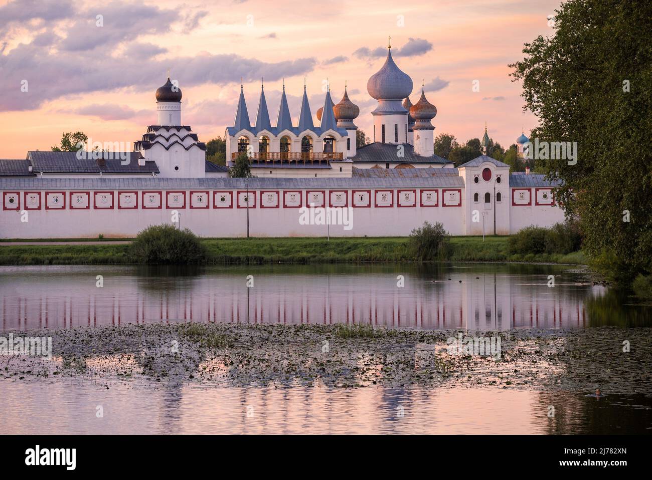 August twilight at the ancient Tikhvin Assumption Monastery. Leningrad region, Russia Stock Photo