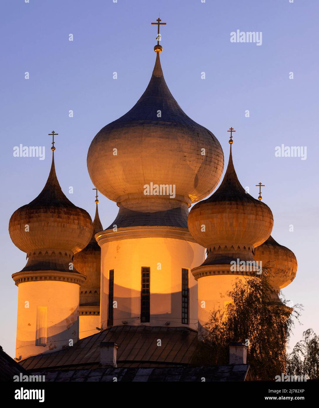 Domes of the Assumption Cathedral of the Tikhvin Assumption Monastery in the evening accent lighting close up. Tikhvin, Leningrad region. Russia Stock Photo