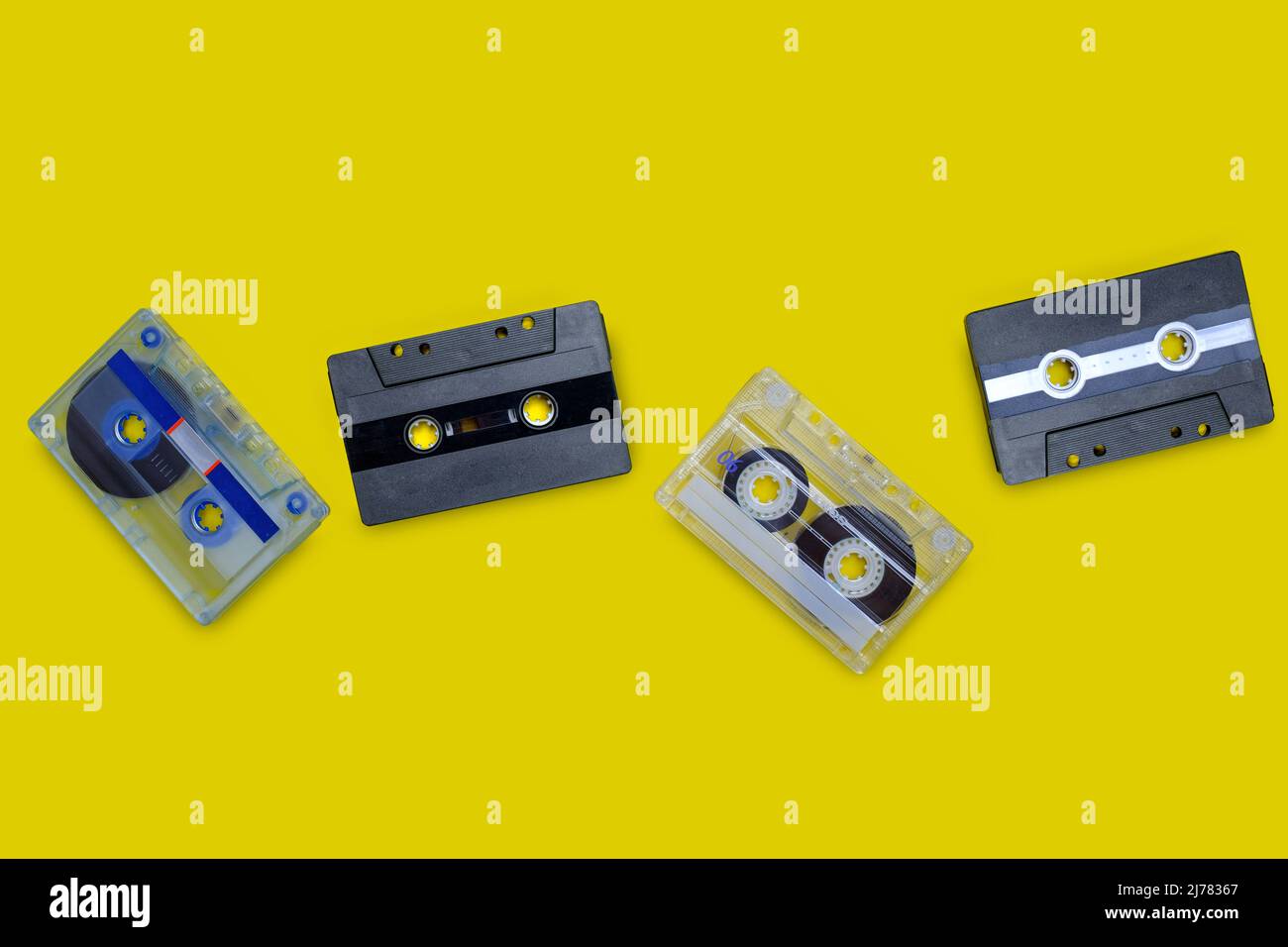 Old compact cassette tape on yellow background Stock Photo