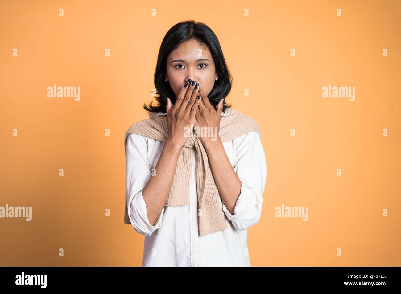 portrait of asian woman covering her mouth with hands Stock Photo - Alamy
