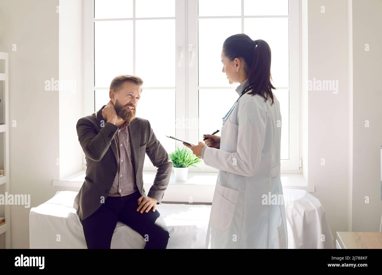 Unwell man have spasm consult with doctor Stock Photo