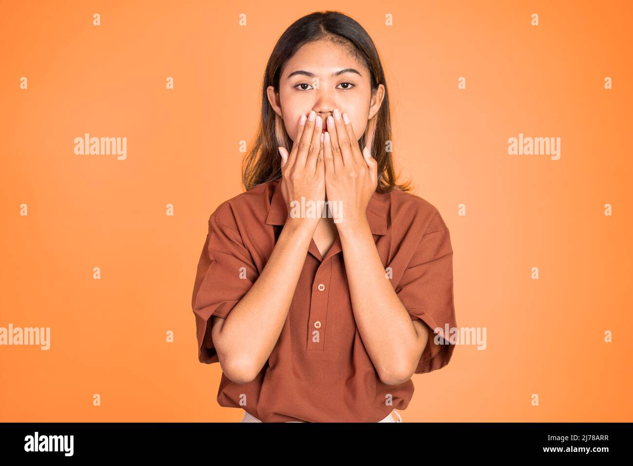 portrait of asian woman covering her mouth with hands Stock Photo - Alamy
