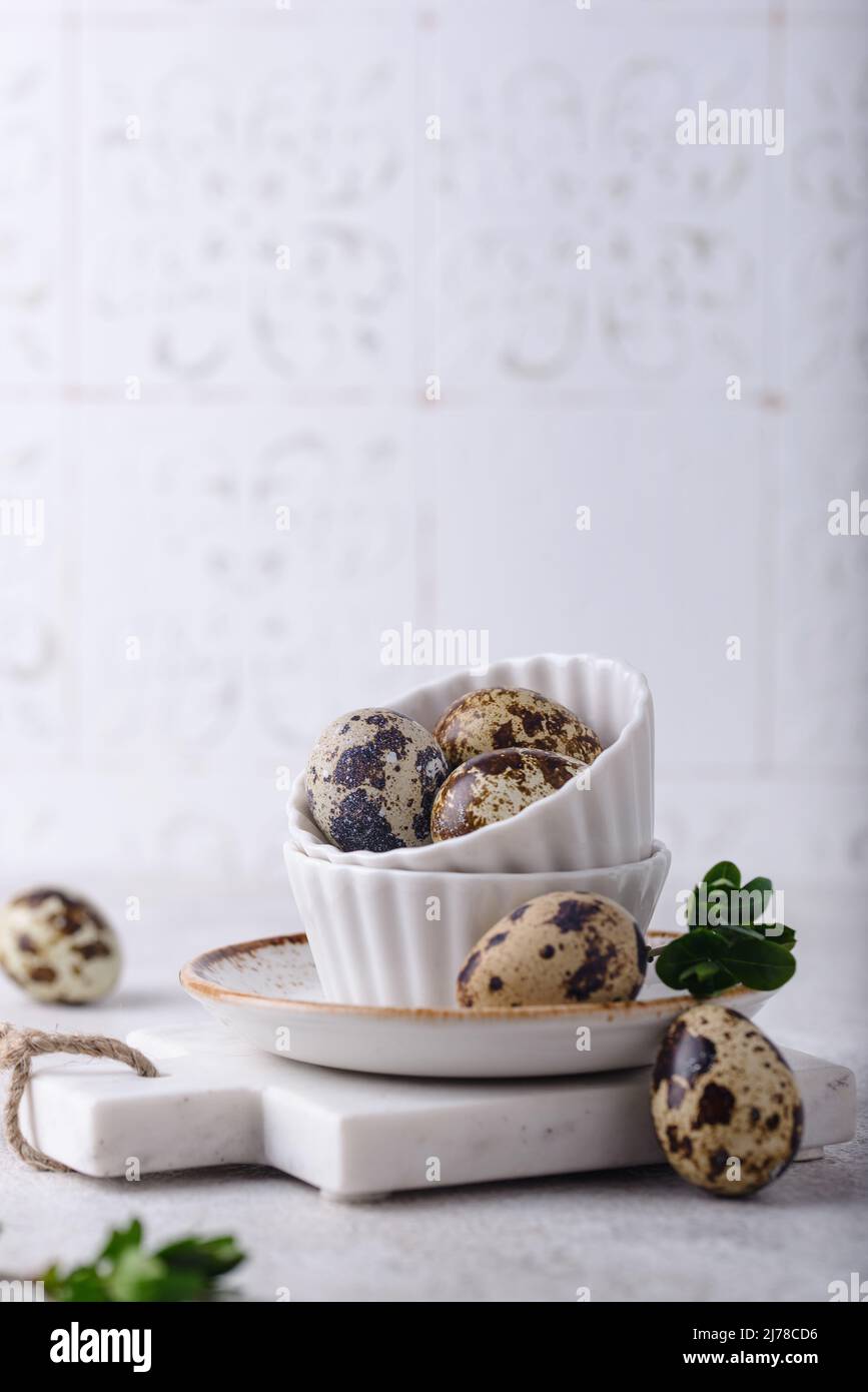 Bowl with quail eggs on light background Stock Photo