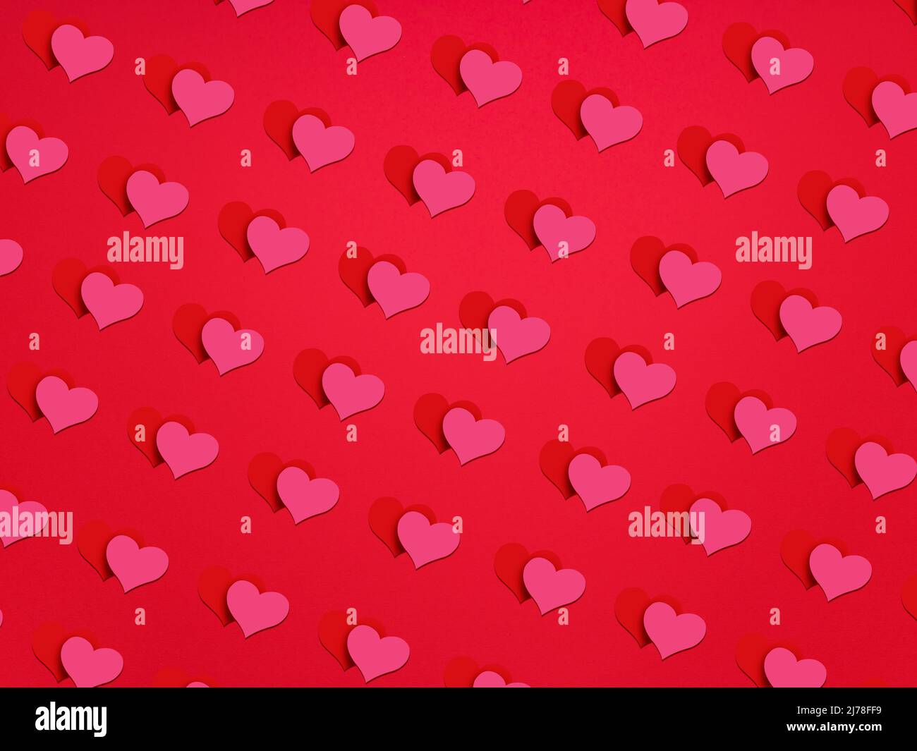 Red background with many double hearts (red and pink), romantic background for Valentine's Day or wedding. Stock Photo