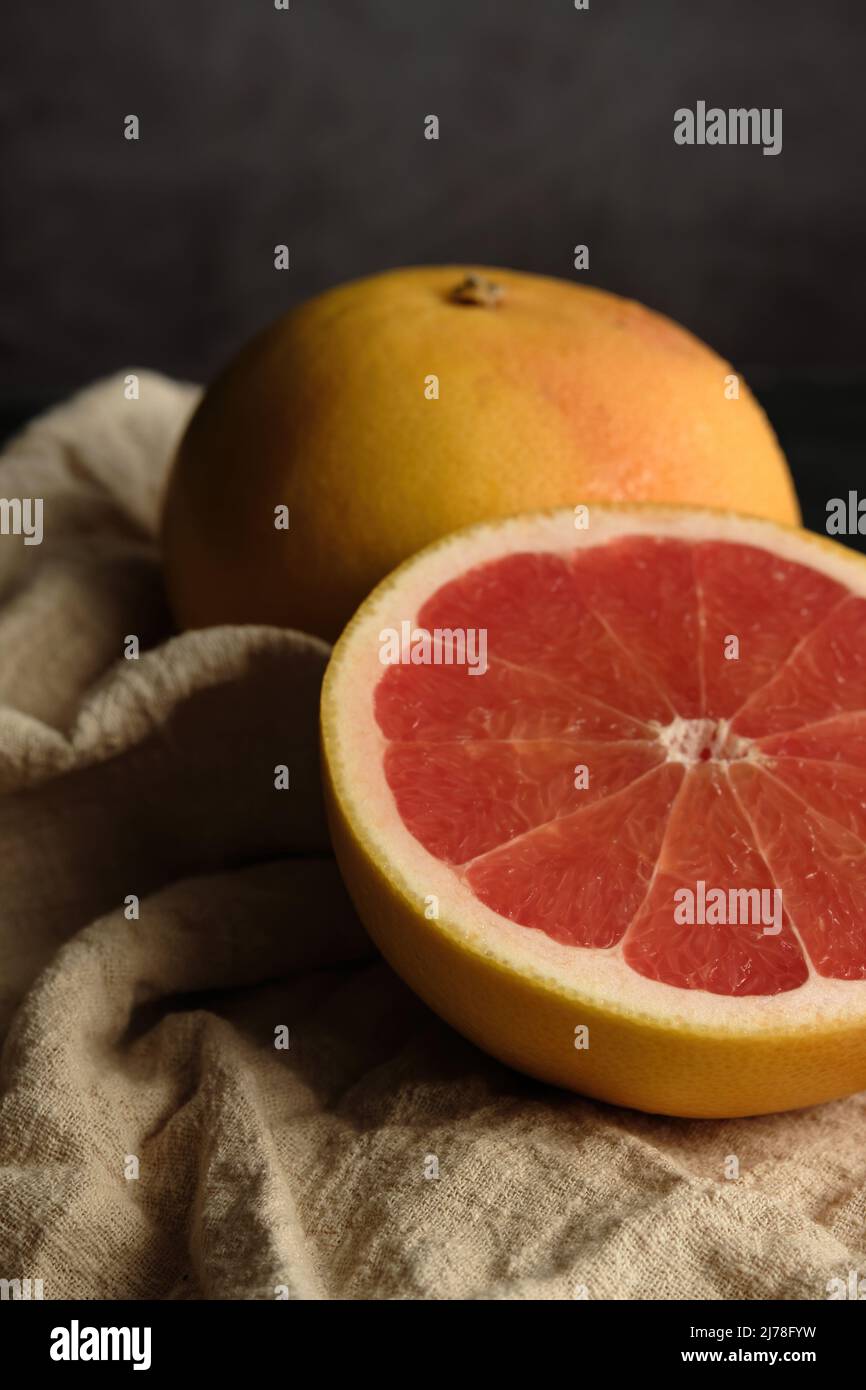 sliced ripe grapefruit on a light cloth Stock Photo