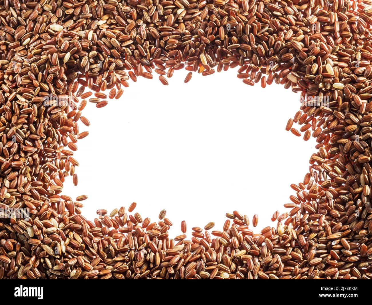 Brown rice - whole grain rice with outer hull or husk arranged as a frame. Top view. Stock Photo