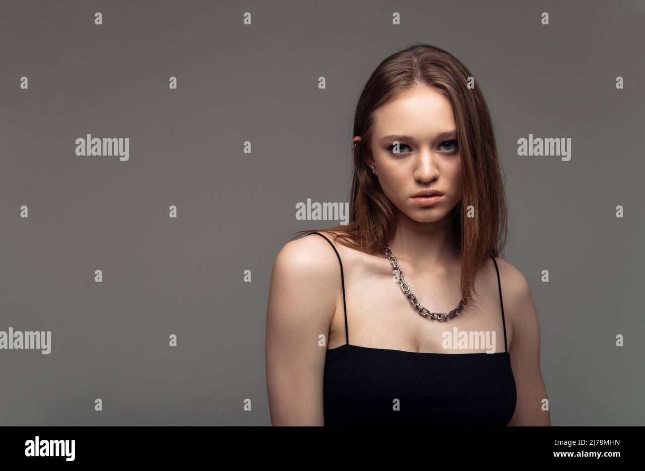 Portrait of sophisticated young woman advertising products and services. Stock Photo