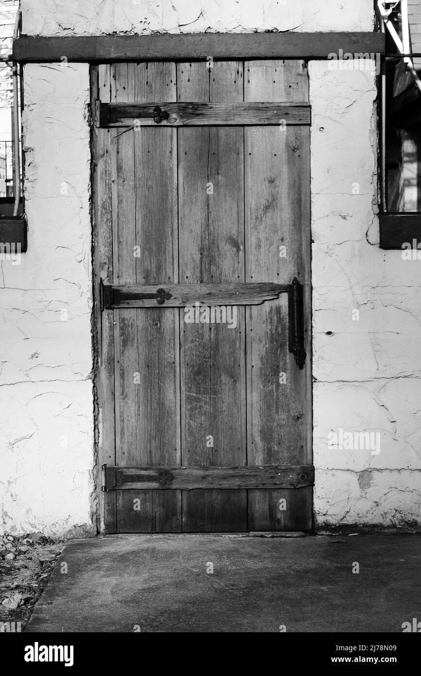 Vintage worn wooden door in black and white. Stock Photo