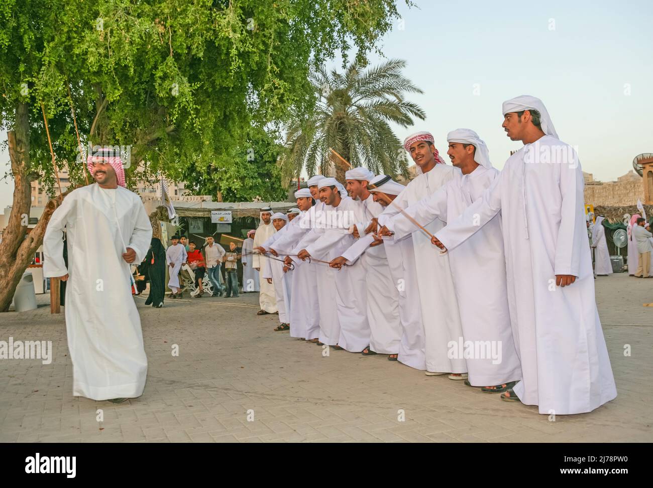 A group of Arab men performing the ayyalah, or stick dance, during Sharjah's Heritage Days Festival. Stock Photo
