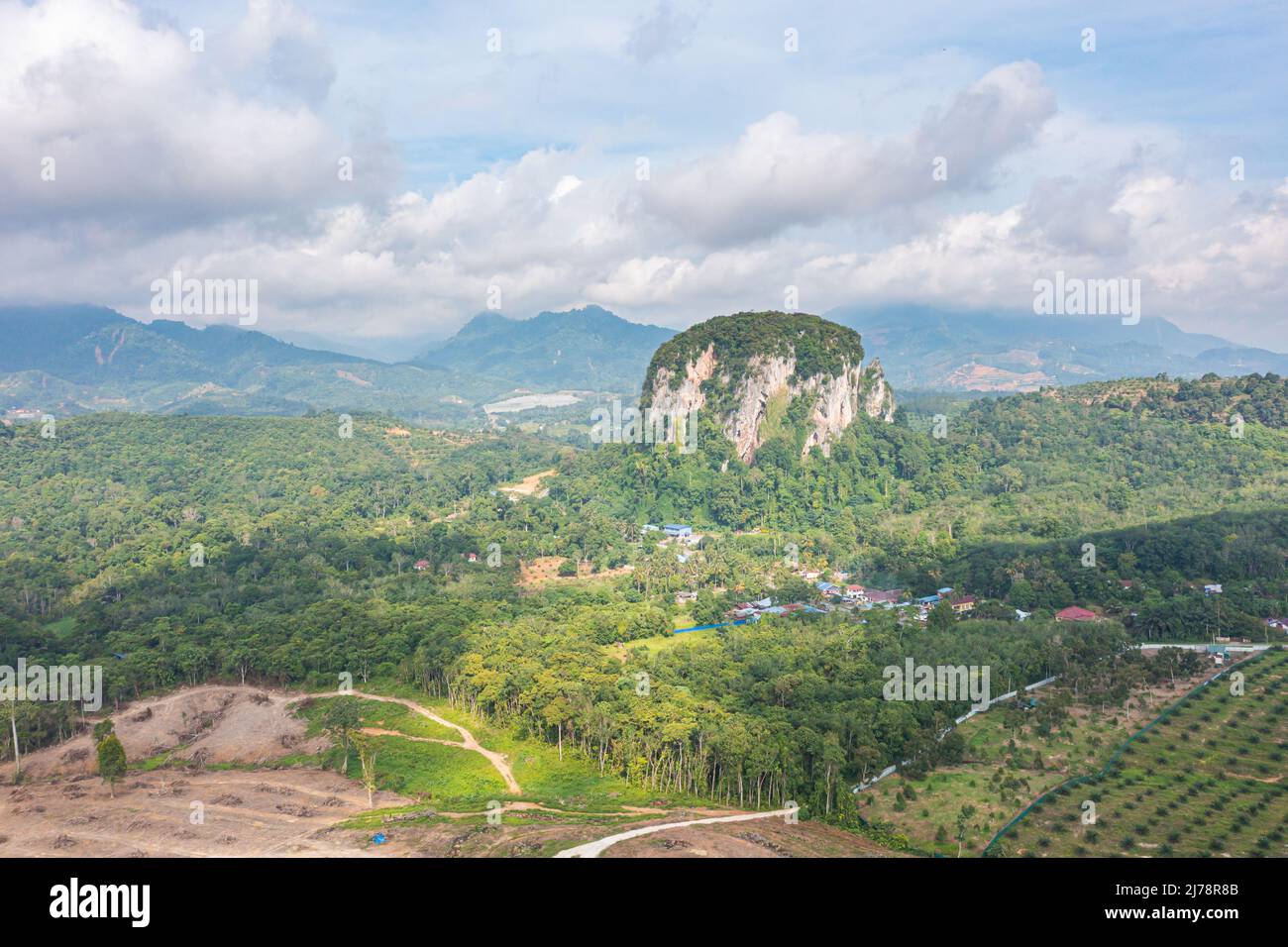 Aerial view to the Limestone hill  Bukit Batu Kapur at Cinta Manis, Pahang, Malaysia. A mountain rock out of nowhere in the middle of the Malaysian ra Stock Photo