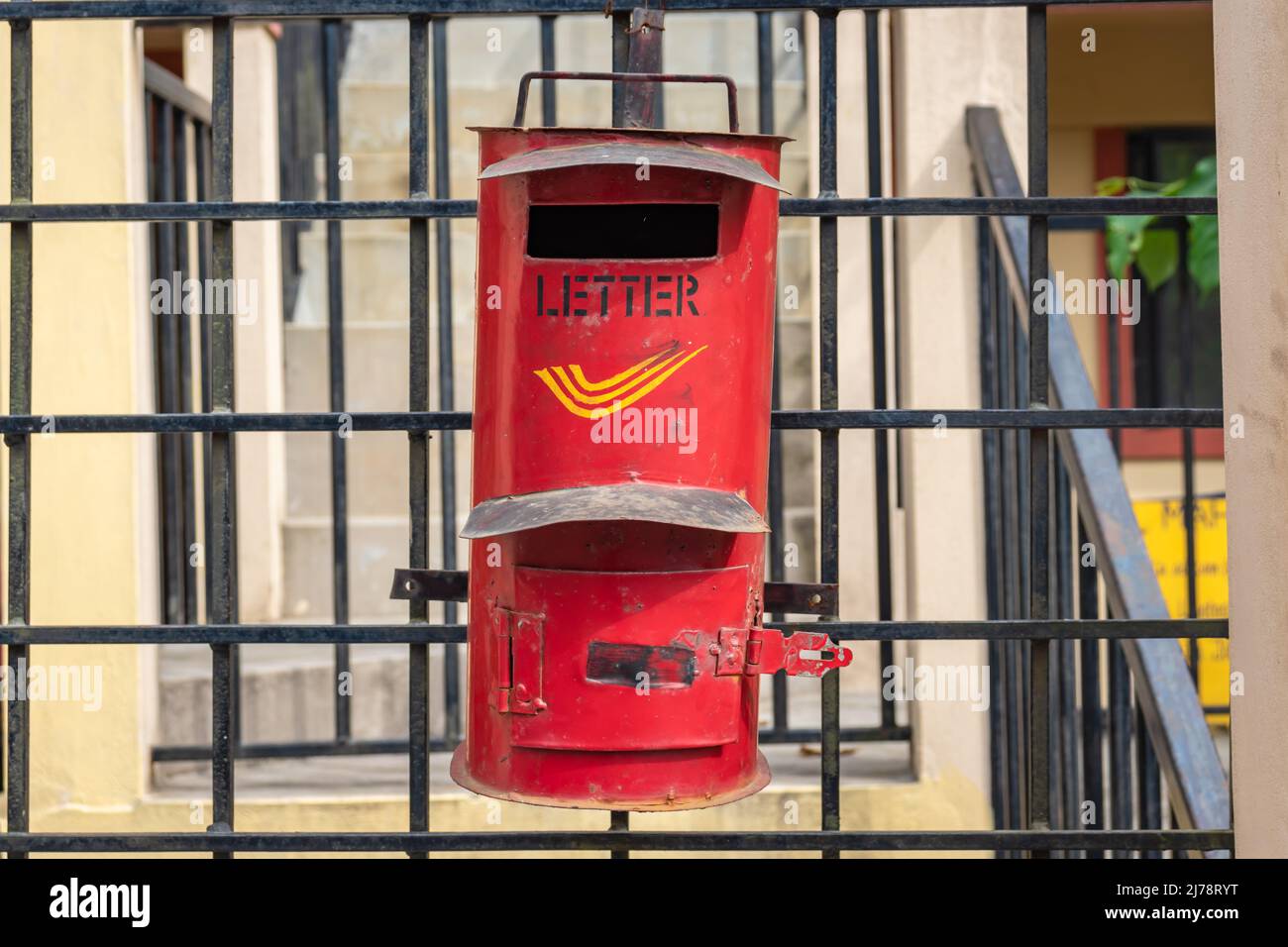 isolated indian postbox hanging at iron pole at post office from front angle Stock Photo