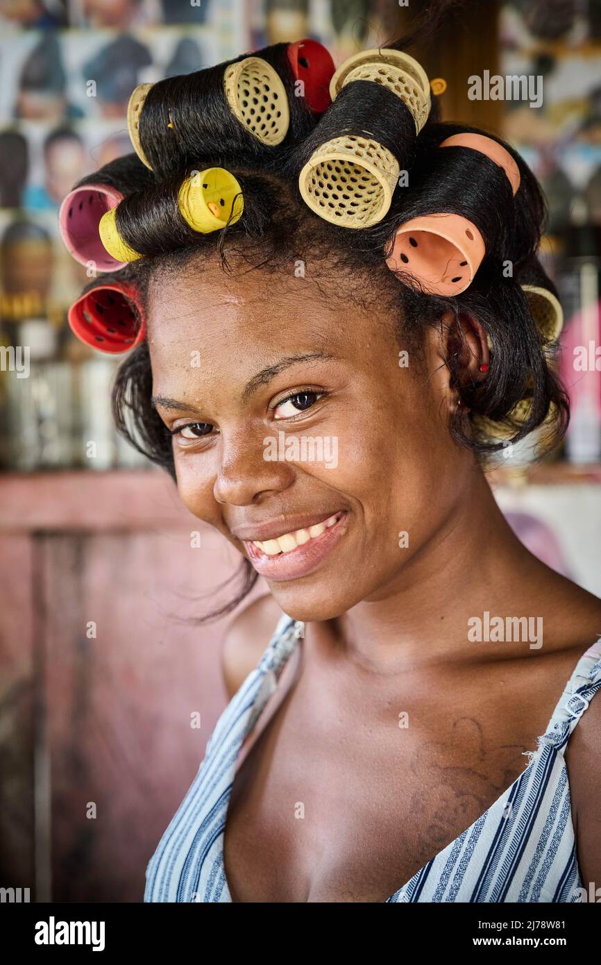 Portrait of a young woman with hair rollers and a tattoo in a beauty salon. Stock Photo