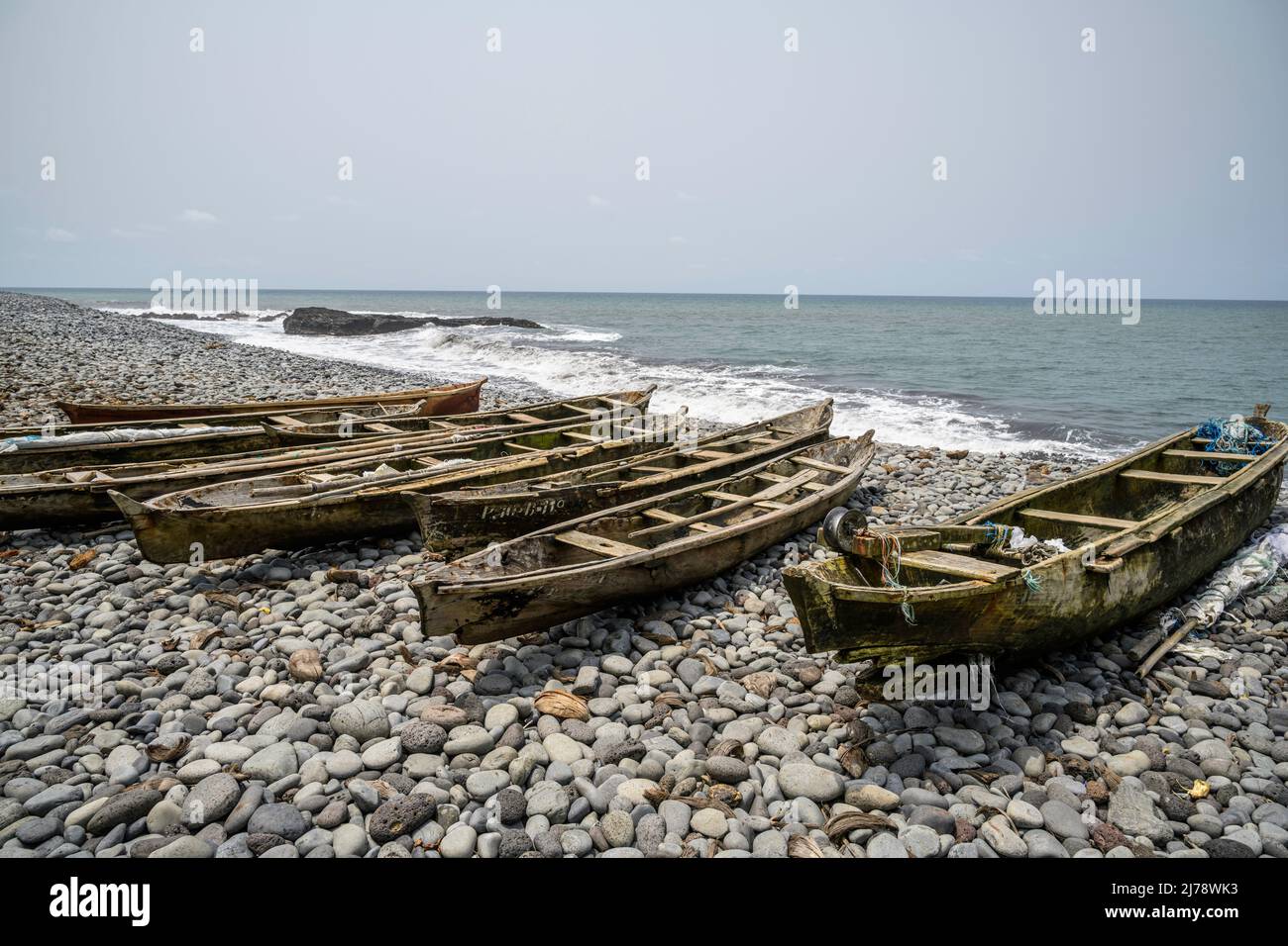 Fishing boats on a rocky beach. Stock Photo