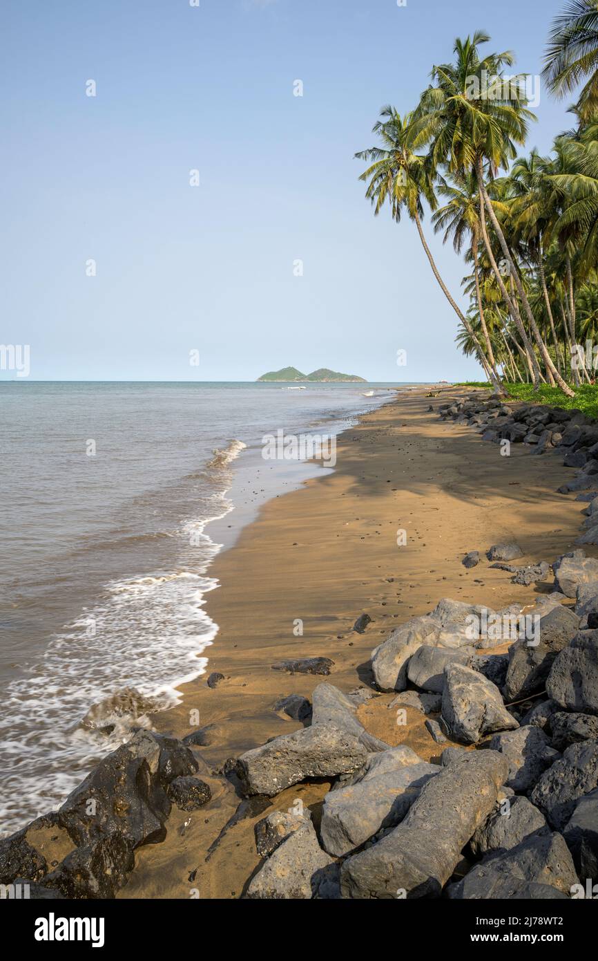 Beach of sand and rocks with the islets of Ilheu das Cabras in the background. Stock Photo