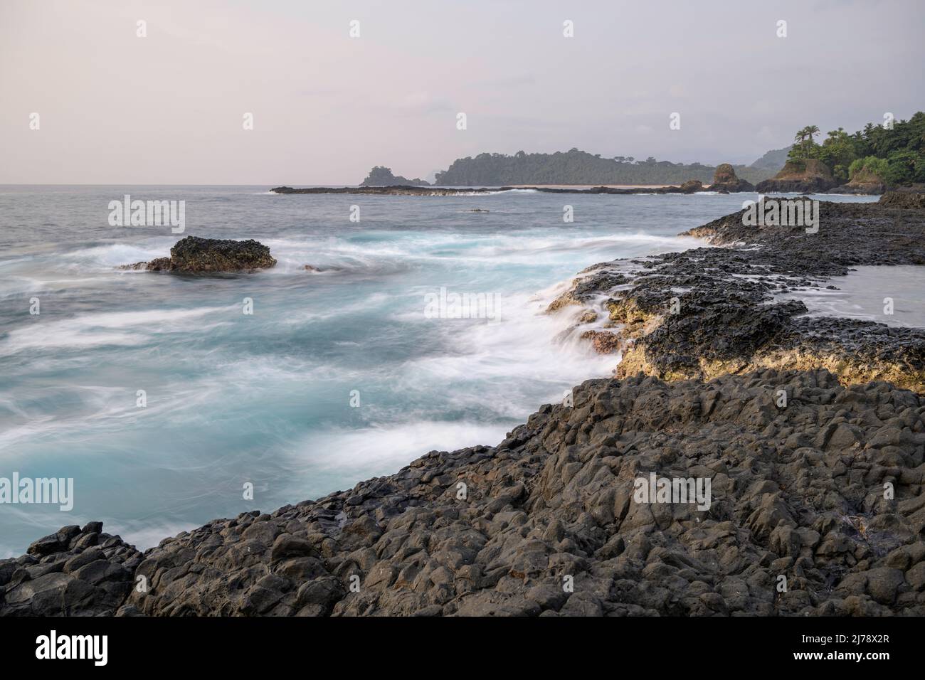 Waves beating on the rocks on the cliffs near Praia Piscina. Stock Photo