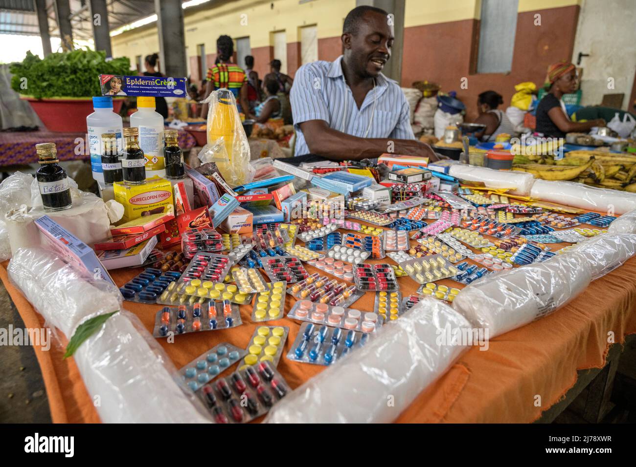 Man selling medicines at a stall in the Bobo Forro market. Stock Photo