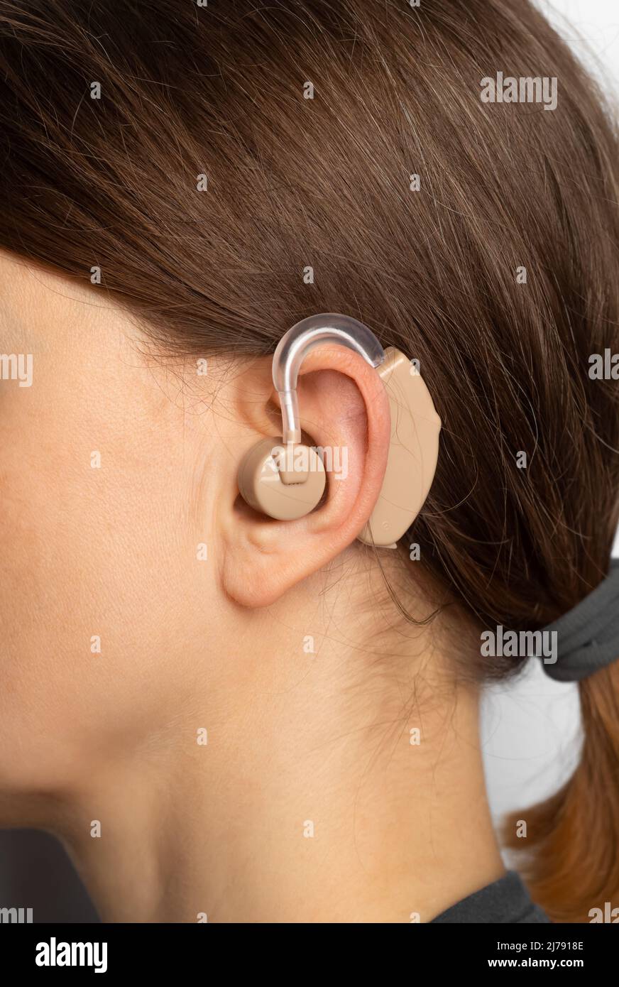 Hearing aid on a woman's ear, close-up. Stock Photo