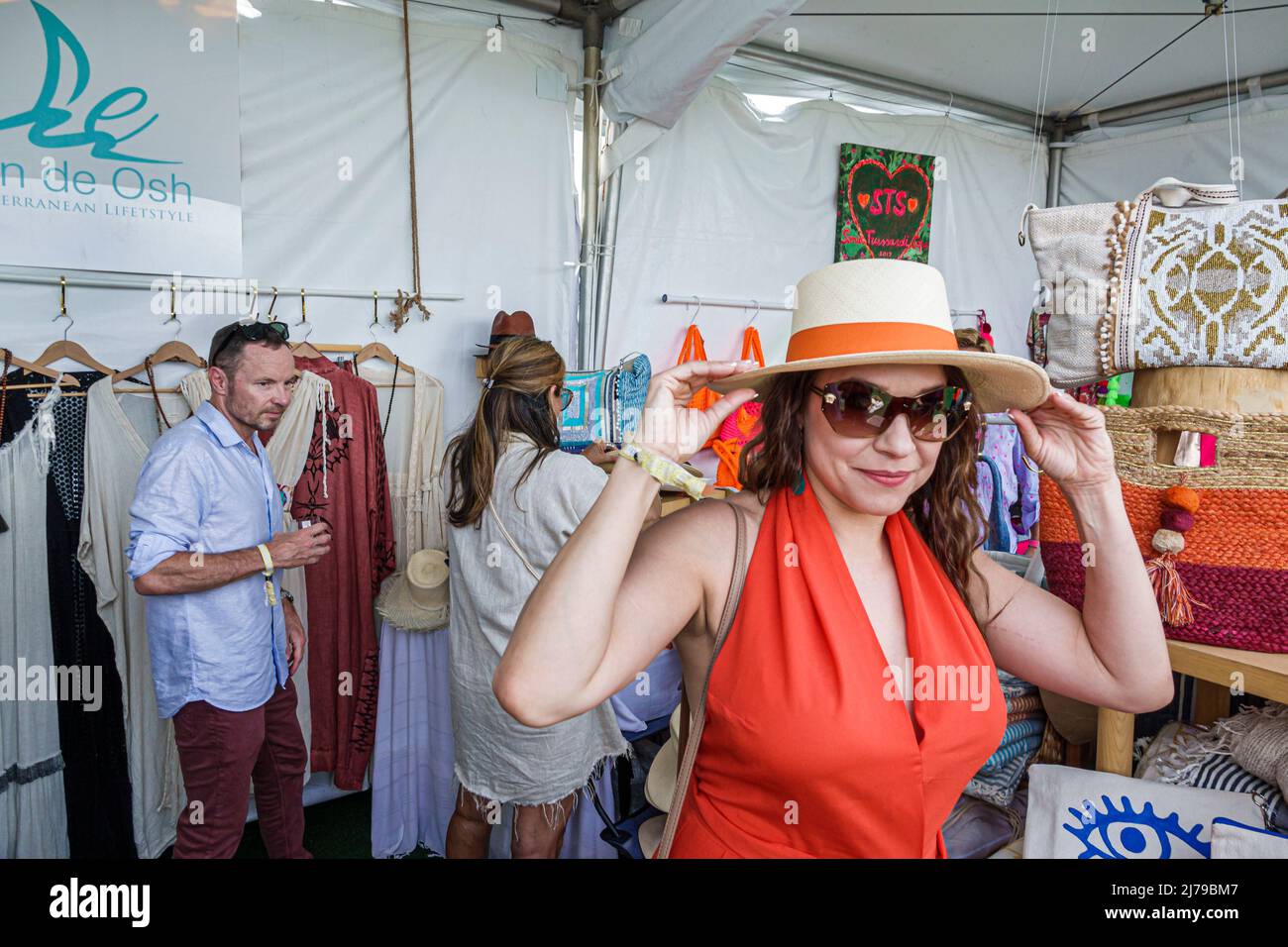 Miami Beach Florida Beach Polo World Cup Miami annual event Retail Village shopping vendors tents clothing display sale fashionable woman wearing hat Stock Photo